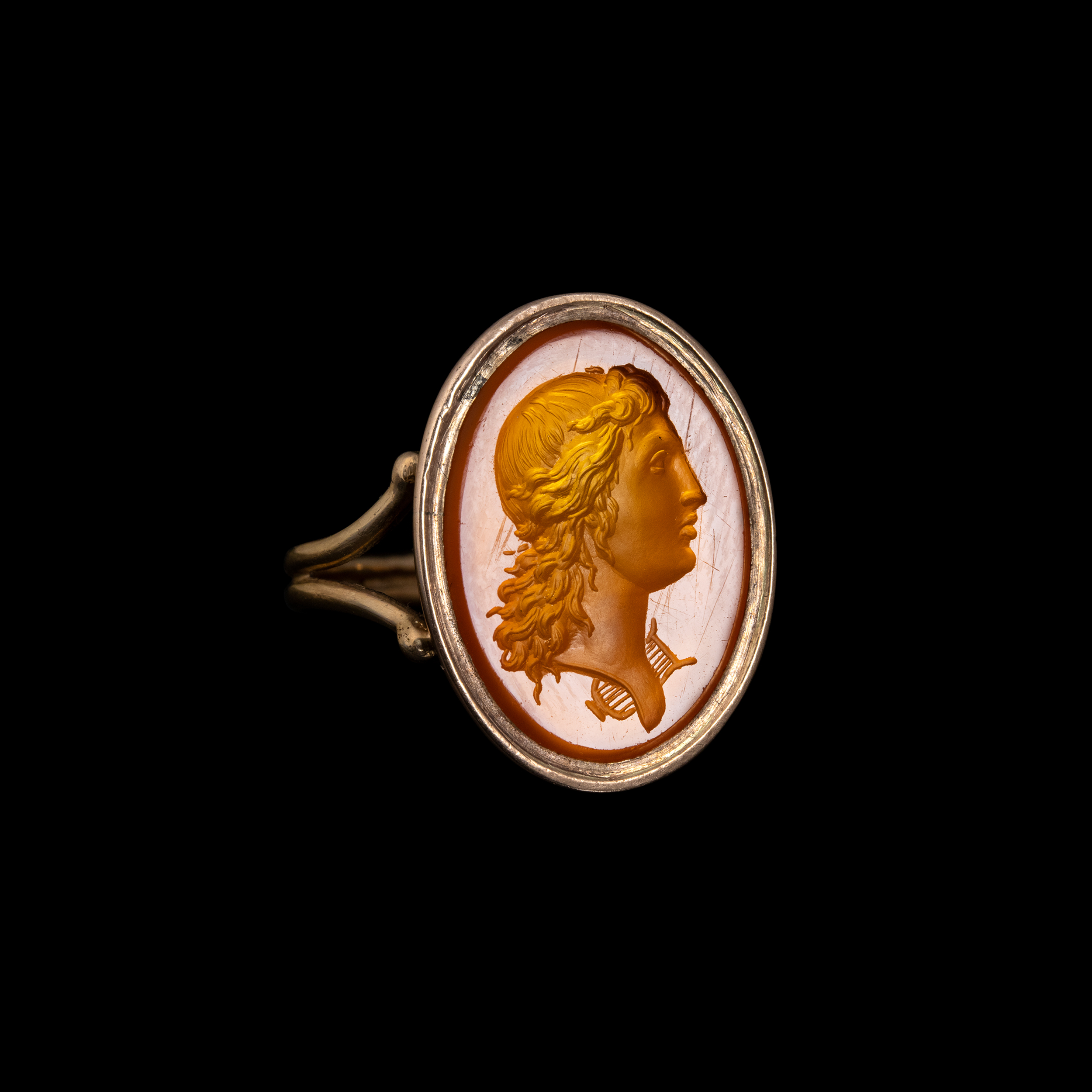 A 19th century gold ring set with a Neoclassical carnelian intaglio. Bust of Apollo. 